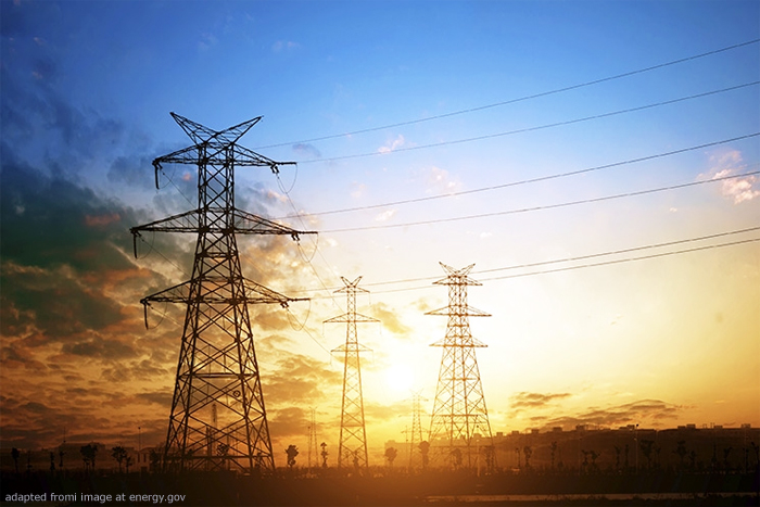 File Photo of Electrical Power Lines in Countryside with Sunset in Background, adapted from image at energy.gov