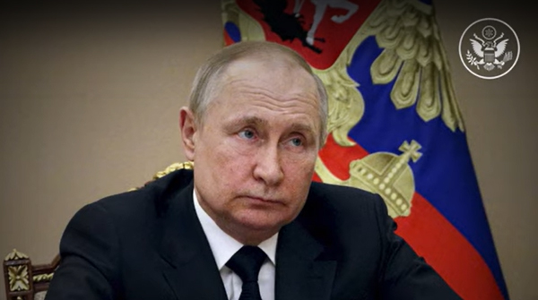 File Photo of Vladimir Putin Sitting Before Flag, adapted from image at sharemerica.gov