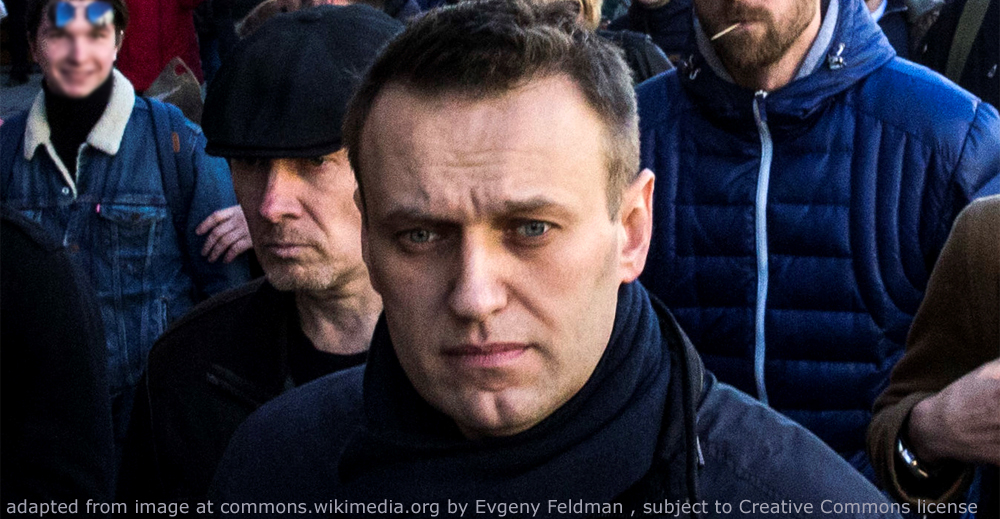 File Photo of Alexei Navalny Marching on Street with Others in Background; adapted from image at commons.wikimedia.org with credit to Evgeny Feldman, subject to Creative Commons license; original image at commons.wikimedia.org/wiki/File:FEV_1795_(cropped1).jpg, with license information at creativecommons.org/licenses/by-sa/4.0/deed.en and creativecommons.org/licenses/by-sa/4.0/legalcode