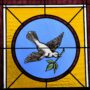 Stained Glass Window Featuring Dove in Flight wiith Olive Branch in Its Bill, adapted from image at .army.mil