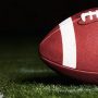 Football on Turf Near Yard Marker