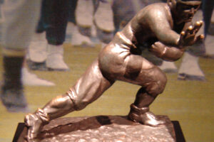 Heisman trophy image derived from photo by Robert J. La Verghetta licensed under the Creative Commons Attribution-Share Alike 2.5 Generic, 2.0 Generic and 1.0 Generic license, governed by restrictions provided therein.